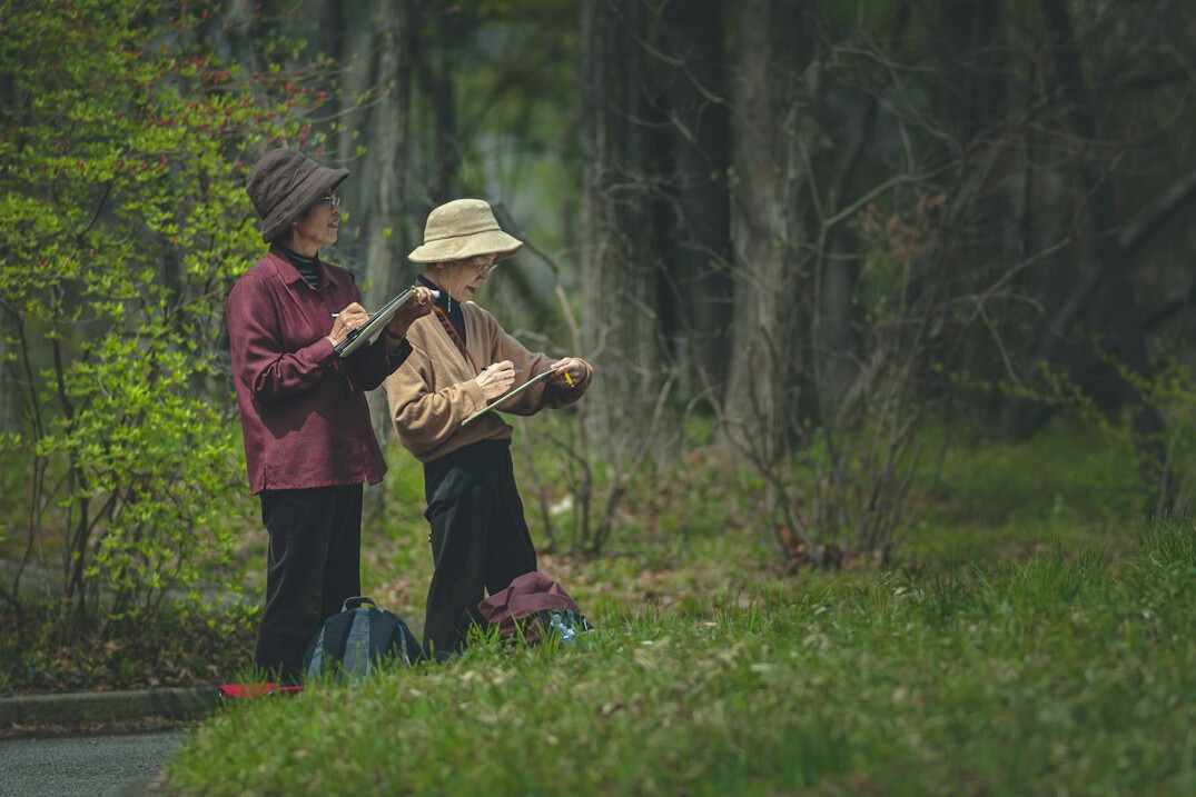 elderly neighbors chatting in garden
